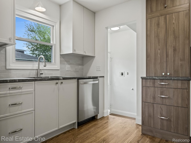 1149 Larkmoor Blvd, Berkley, MI 48072 - kitchen featuring dishwasher, a sink, wood finished floors, white cabinets, and backsplash