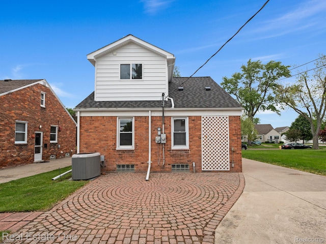 1149 Larkmoor Blvd, Berkley, MI 48072 - rear view of property with central air condition unit, brick siding, roof with shingles, and curved driveway