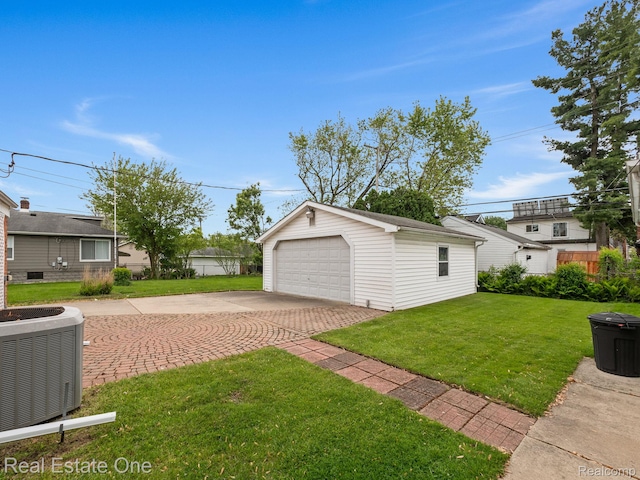 1149 Larkmoor Blvd, Berkley, MI 48072 - view of green lawn featuring cooling unit, a garage, and an outbuilding