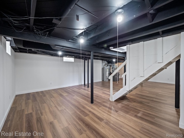 1149 Larkmoor Blvd, Berkley, MI 48072 - finished basement featuring stairway, wood finished floors, baseboards, and gas water heater