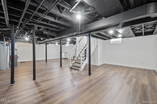 1149 Larkmoor Blvd, Berkley, MI 48072 - below grade area with water heater, stairway, baseboards, and wood finished floors