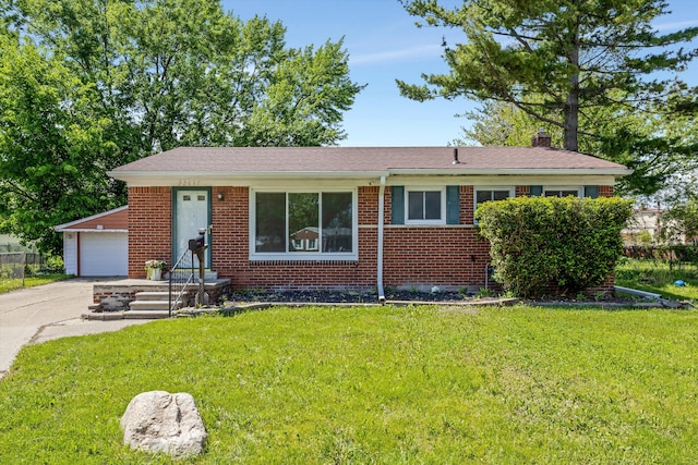 22637 Karam Ct, Warren, MI 48091 - view of front of home with a chimney, brick siding, a garage, and a front yard