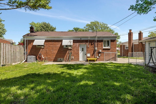 22637 Karam Ct, Warren, MI 48091 - back of house featuring brick siding, central air condition unit, and a chimney
