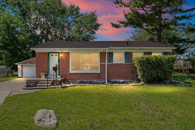 22637 Karam Ct, Warren, MI 48091 - view of front of home featuring brick siding, a yard, and a garage