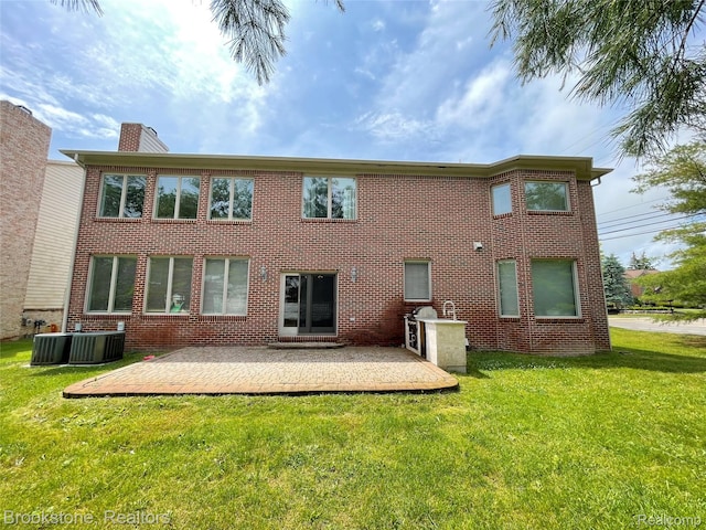 2115 Aldwin Dr, West Bloomfield, MI 48324 - rear view of house with a patio area, a yard, a chimney, and brick siding