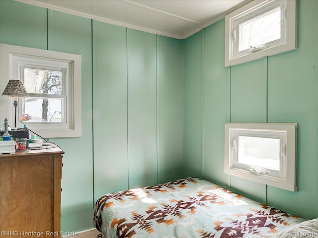 5222 S Channel Dr, Harsens Island, MI 48028 - bedroom with a decorative wall and multiple windows