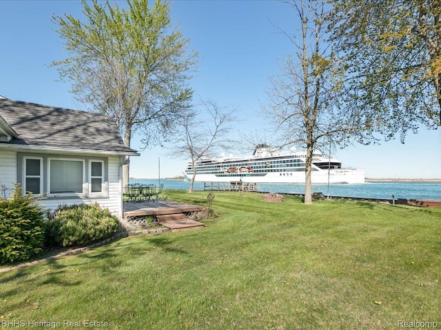 5222 S Channel Dr, Harsens Island, MI 48028 - view of grassy yard featuring a deck with water view