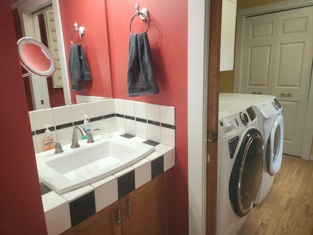 9332 W 10 Mile Rd, Irons, MI 49644 - washroom with washing machine and clothes dryer and light wood-style flooring