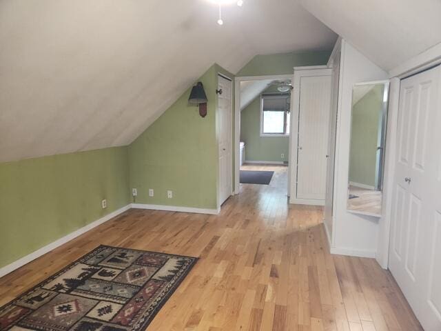 9332 W 10 Mile Rd, Irons, MI 49644 - additional living space featuring wood finished floors, vaulted ceiling, and baseboards