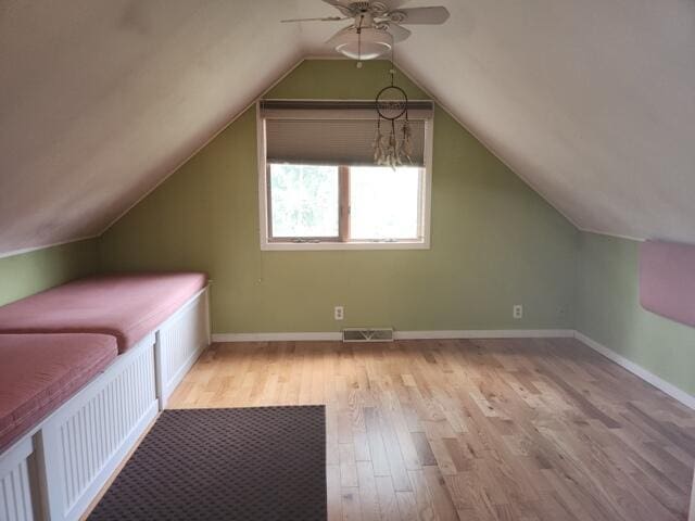 9332 W 10 Mile Rd, Irons, MI 49644 - additional living space with ceiling fan, light wood finished floors, vaulted ceiling, and baseboards