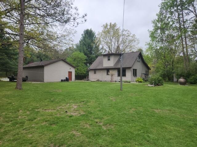 9332 W 10 Mile Rd, Irons, MI 49644 - back of house with a yard