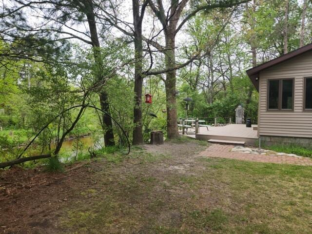 9332 W 10 Mile Rd, Irons, MI 49644 - view of yard featuring a deck