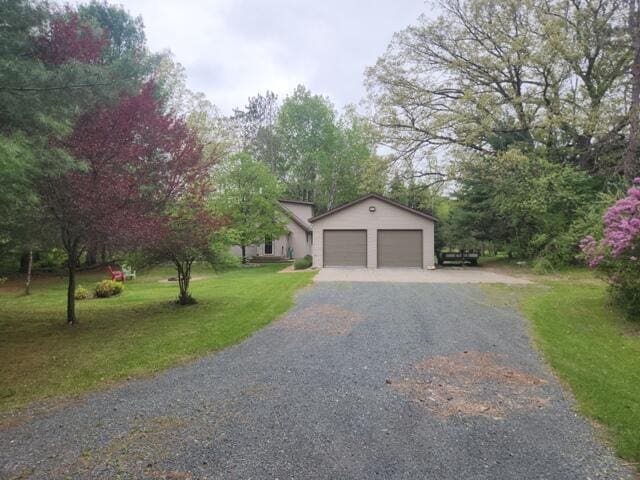9332 W 10 Mile Rd, Irons, MI 49644 - view of front of house with driveway and a front yard