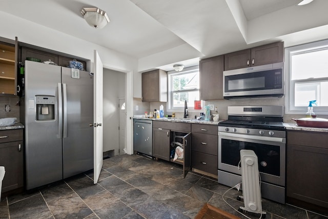 13722 Birrell St, Southgate, MI 48195 - kitchen with appliances with stainless steel finishes, a sink, dark brown cabinets, and dark stone finish floors