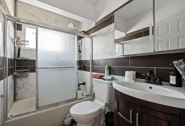 13722 Birrell St, Southgate, MI 48195 - full bath featuring shower / bath combination with glass door, backsplash, toilet, vanity, and tile walls