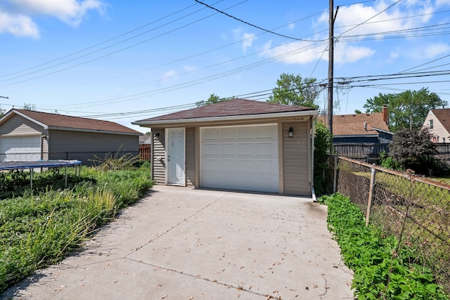 13722 Birrell St, Southgate, MI 48195 - detached garage with concrete driveway and a trampoline