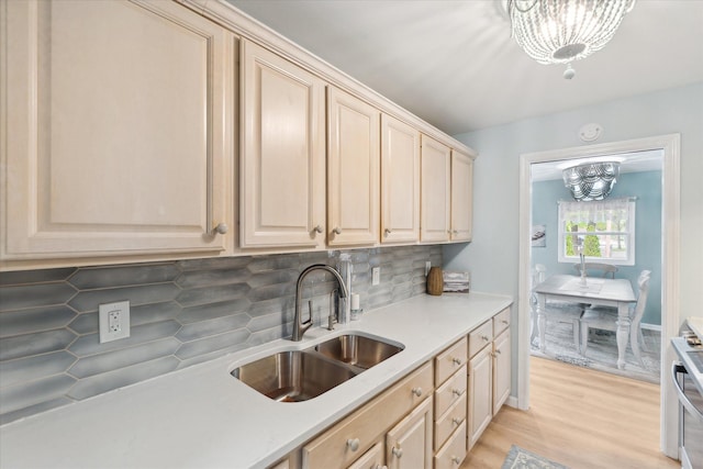 3761 Hunt Rd, Lapeer, MI 48446 - kitchen featuring a sink, a chandelier, light brown cabinets, and light countertops