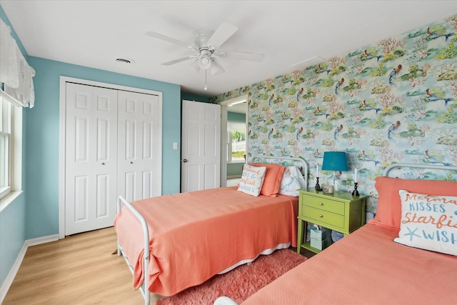 3761 Hunt Rd, Lapeer, MI 48446 - bedroom with baseboards, light wood-style flooring, a closet, and a ceiling fan