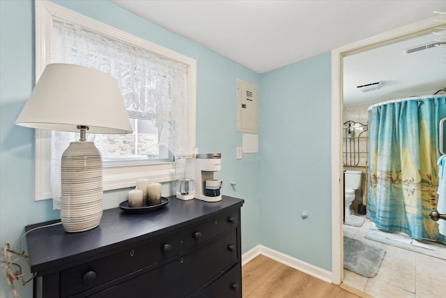 3761 Hunt Rd, Lapeer, MI 48446 - full bathroom with toilet, baseboards, curtained shower, and electric panel