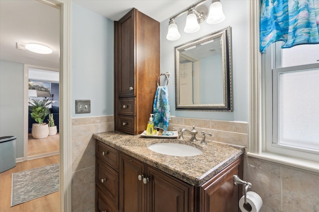 3761 Hunt Rd, Lapeer, MI 48446 - bathroom with tile walls, vanity, and wainscoting