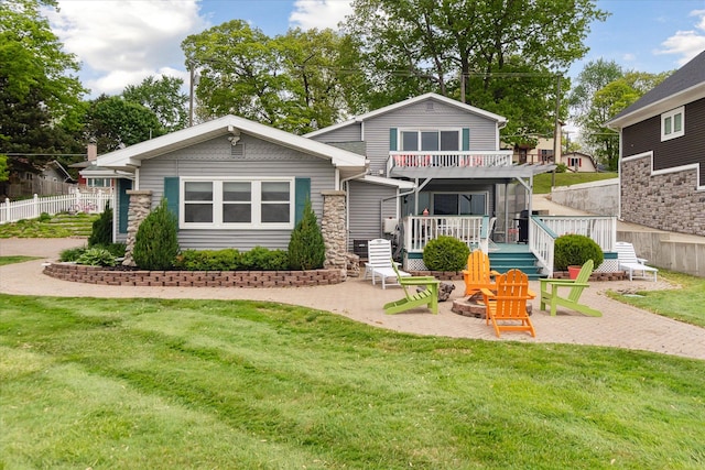 3761 Hunt Rd, Lapeer, MI 48446 - view of front of property featuring an outdoor fire pit, a balcony, a patio, stone siding, and a wooden deck