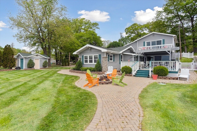 3761 Hunt Rd, Lapeer, MI 48446 - view of front of home with an outdoor fire pit, a deck, a front lawn, and a patio area