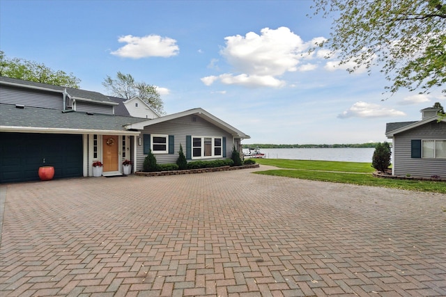 3761 Hunt Rd, Lapeer, MI 48446 - view of front of home featuring a water view, decorative driveway, and an attached garage