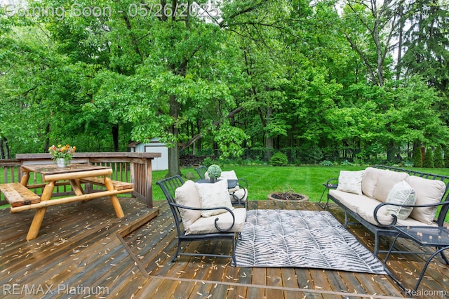 638 Glenwyth Rd, Brighton, MI 48116 - deck featuring an outdoor living space with a fire pit, a lawn, outdoor dining area, and view of scattered trees