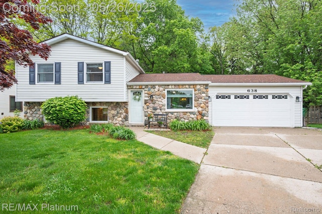 638 Glenwyth Rd, Brighton, MI 48116 - tri-level home featuring an attached garage, stone siding, concrete driveway, and a front yard