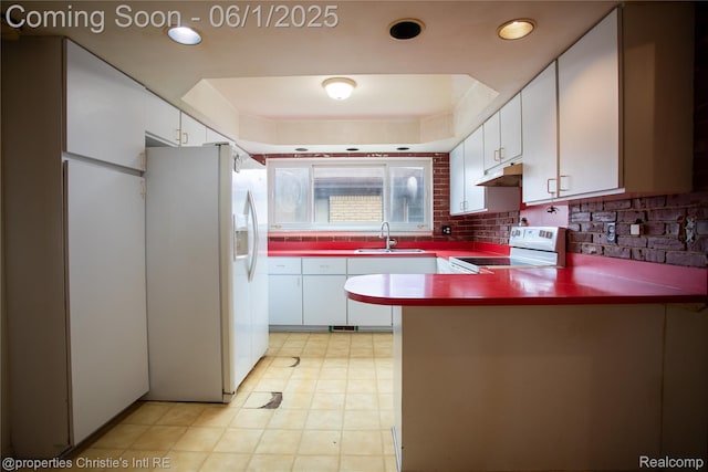 30571 Cedars Dr, Warren, MI 48093 - kitchen featuring white appliances, a sink, a peninsula, under cabinet range hood, and white cabinetry