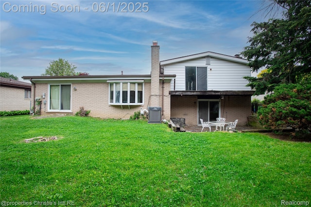 30571 Cedars Dr, Warren, MI 48093 - rear view of property featuring brick siding, a lawn, and central air condition unit