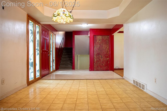 30571 Cedars Dr, Warren, MI 48093 - foyer featuring stairway, a raised ceiling, and baseboards