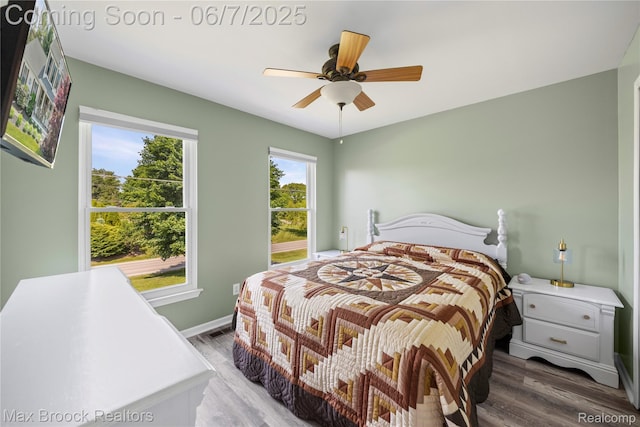 9863 Marshall Rd, South Lyon, MI 48178 - bedroom featuring wood finished floors, ceiling fan, and baseboards