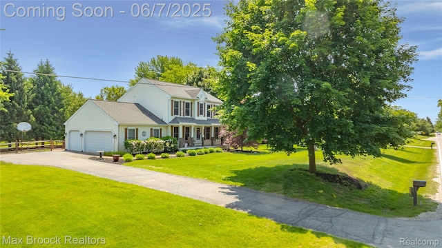 9863 Marshall Rd, South Lyon, MI 48178 - view of front of home with a garage, a porch, and driveway
