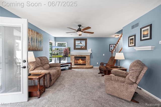 9863 Marshall Rd, South Lyon, MI 48178 - carpeted living room with ceiling fan, baseboards, a fireplace, and stairs