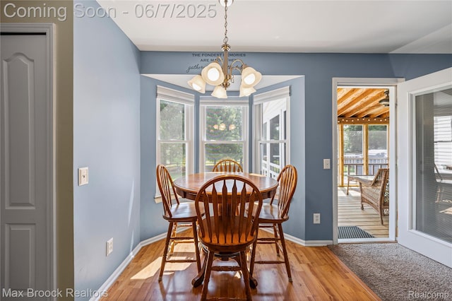 9863 Marshall Rd, South Lyon, MI 48178 - dining area featuring a chandelier, plenty of natural light, baseboards, and light wood-style flooring
