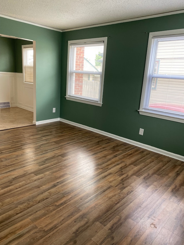 13020 Castle St, Southgate, MI 48195 - empty room with ornamental molding, a textured ceiling, dark wood-style floors, and plenty of natural light