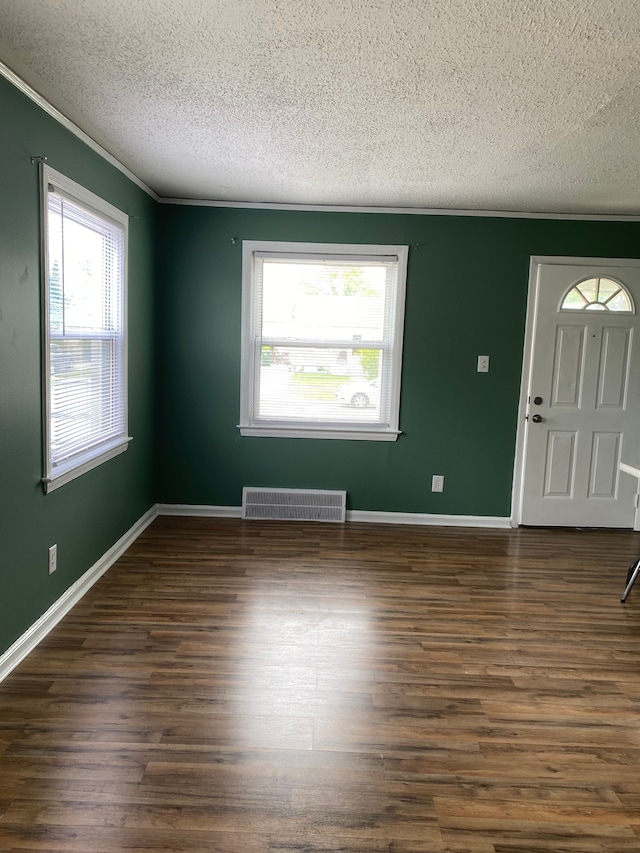 13020 Castle St, Southgate, MI 48195 - entrance foyer with a textured ceiling, plenty of natural light, crown molding, dark wood-style flooring, and baseboards