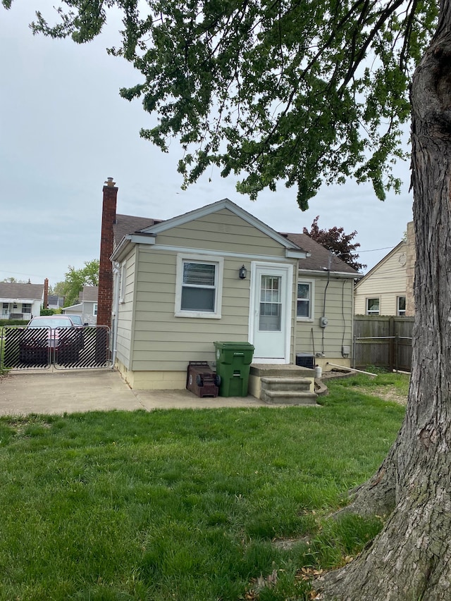 13020 Castle St, Southgate, MI 48195 - rear view of house with a chimney and a patio area