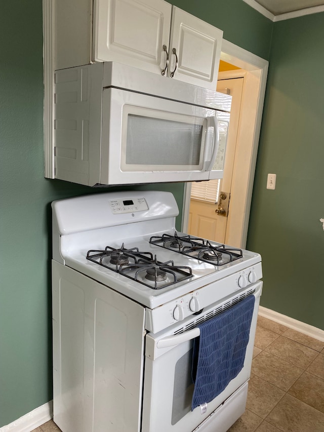 13020 Castle St, Southgate, MI 48195 - kitchen featuring white appliances, baseboards, and light tile patterned floors