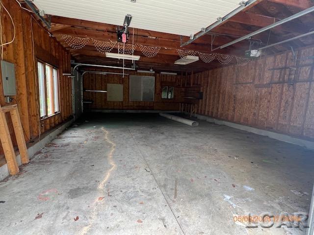 6730 Summerfield Rd, Temperance, MI 48182 - garage with electric panel and a garage door opener