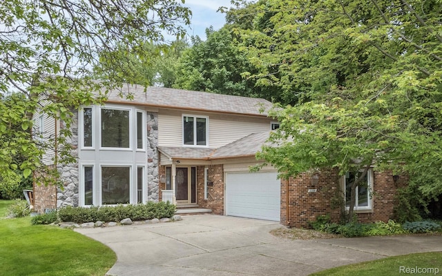 2264 W Maple Rd, Bloomfield Hills, MI 48301 - view of front of property with concrete driveway, an attached garage, and brick siding