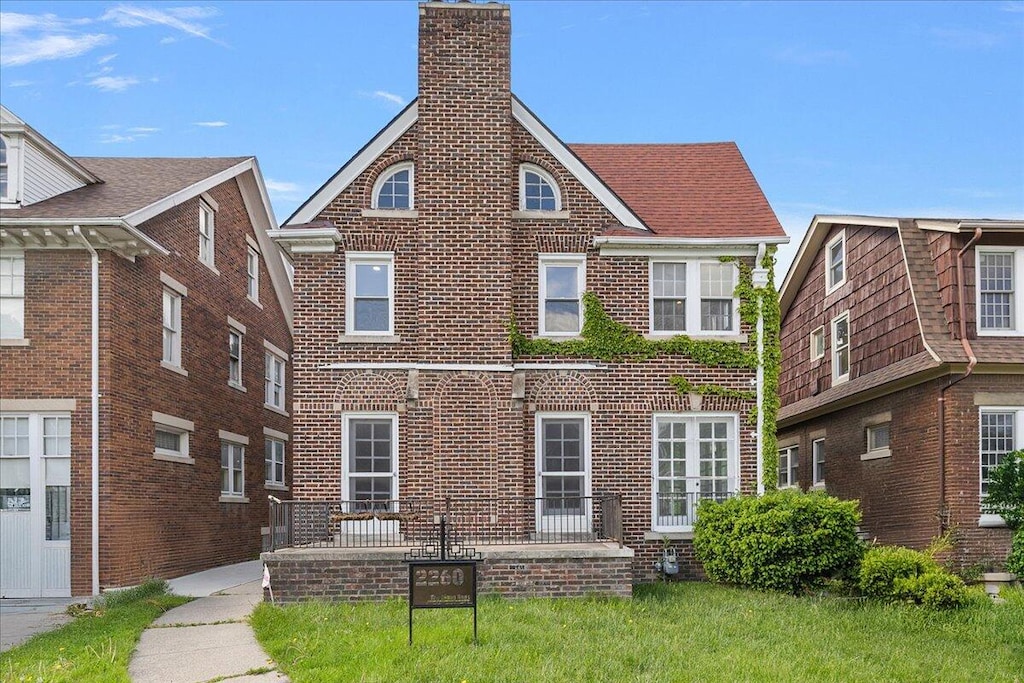 2260 Atkinson St, Detroit, MI 48206 - rear view of property featuring a chimney and brick siding