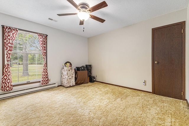 7719 Guenthardt Rd, Manistee, MI 49660 - spare room featuring carpet, a ceiling fan, a textured ceiling, and baseboards