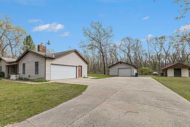 7719 Guenthardt Rd, Manistee, MI 49660 - view of front of house featuring a chimney, a front lawn, and a garage
