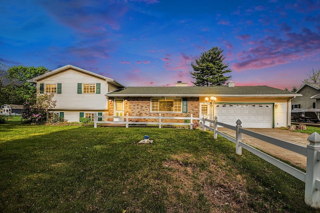 823 W Park Dr, Niles, MI 49120 - split level home with an attached garage, driveway, a chimney, and brick siding
