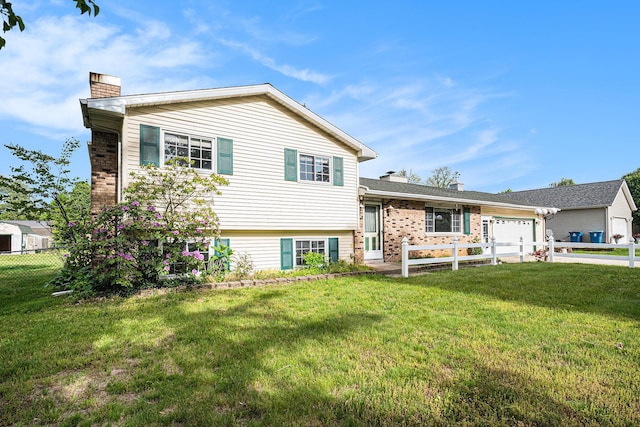 823 W Park Dr, Niles, MI 49120 - tri-level home featuring a chimney, a garage, brick siding, and concrete driveway