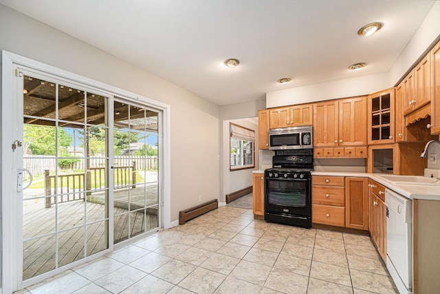 823 W Park Dr, Niles, MI 49120 - kitchen featuring black gas range, a sink, stainless steel microwave, white dishwasher, and baseboard heating