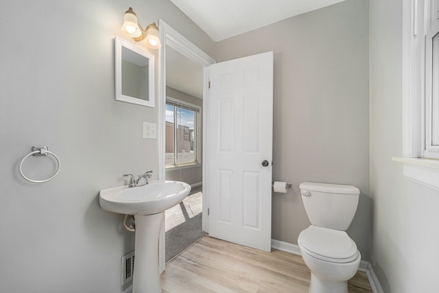 50 Elm St, River Rouge, MI 48218 - bathroom with toilet, wood finished floors, a sink, and baseboards