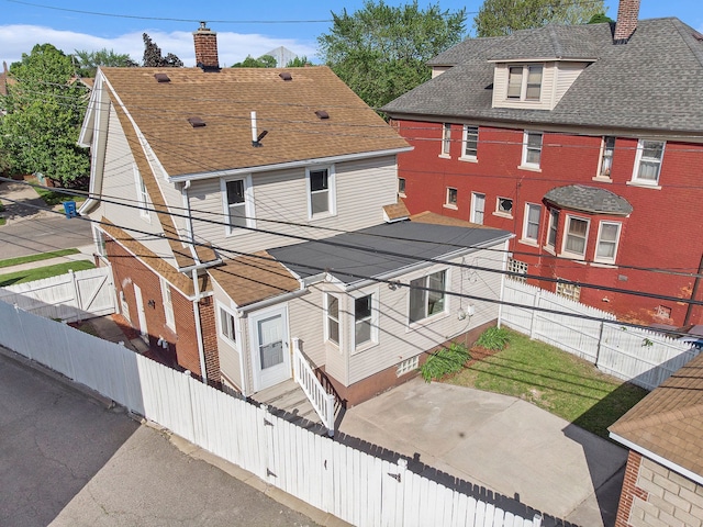 50 Elm St, River Rouge, MI 48218 - view of front facade featuring a chimney, a fenced backyard, and a shingled roof